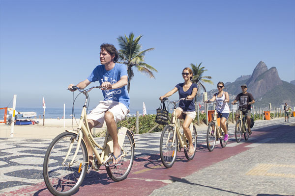 Bike tours in Rio de Janeiro along the beach of Ipanema with palm trees and a great view